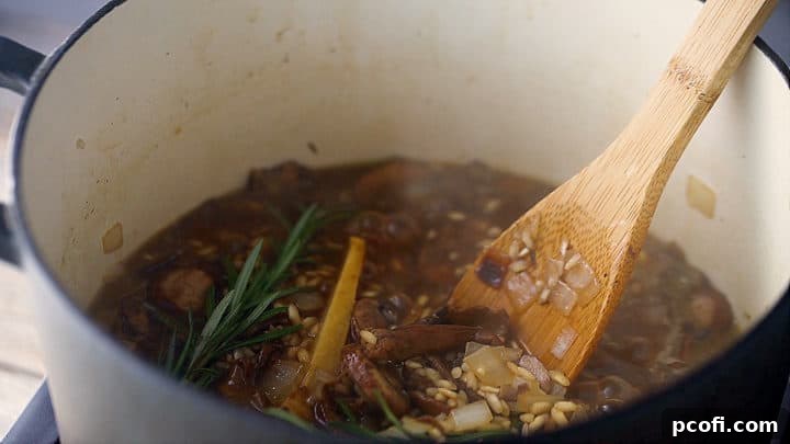 Simmering mushroom risotto with stock.