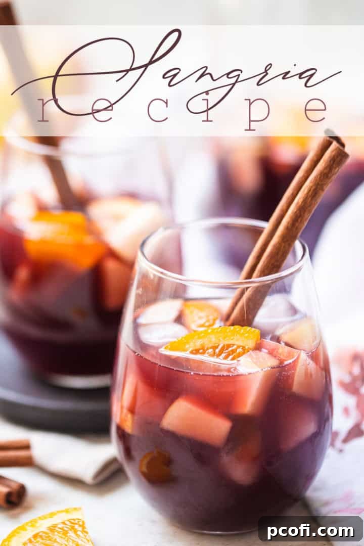 A pitcher of sangria overflowing with fresh fruit slices, ready to be poured into elegant glasses, showcasing its vibrant color and inviting presentation.