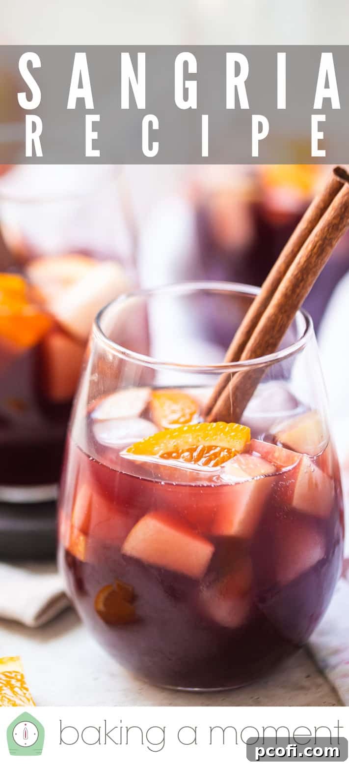 A vibrant pitcher of sangria, showcasing an array of fresh oranges and apples, ready to be served, accompanied by the text 'Sangria Recipe'.