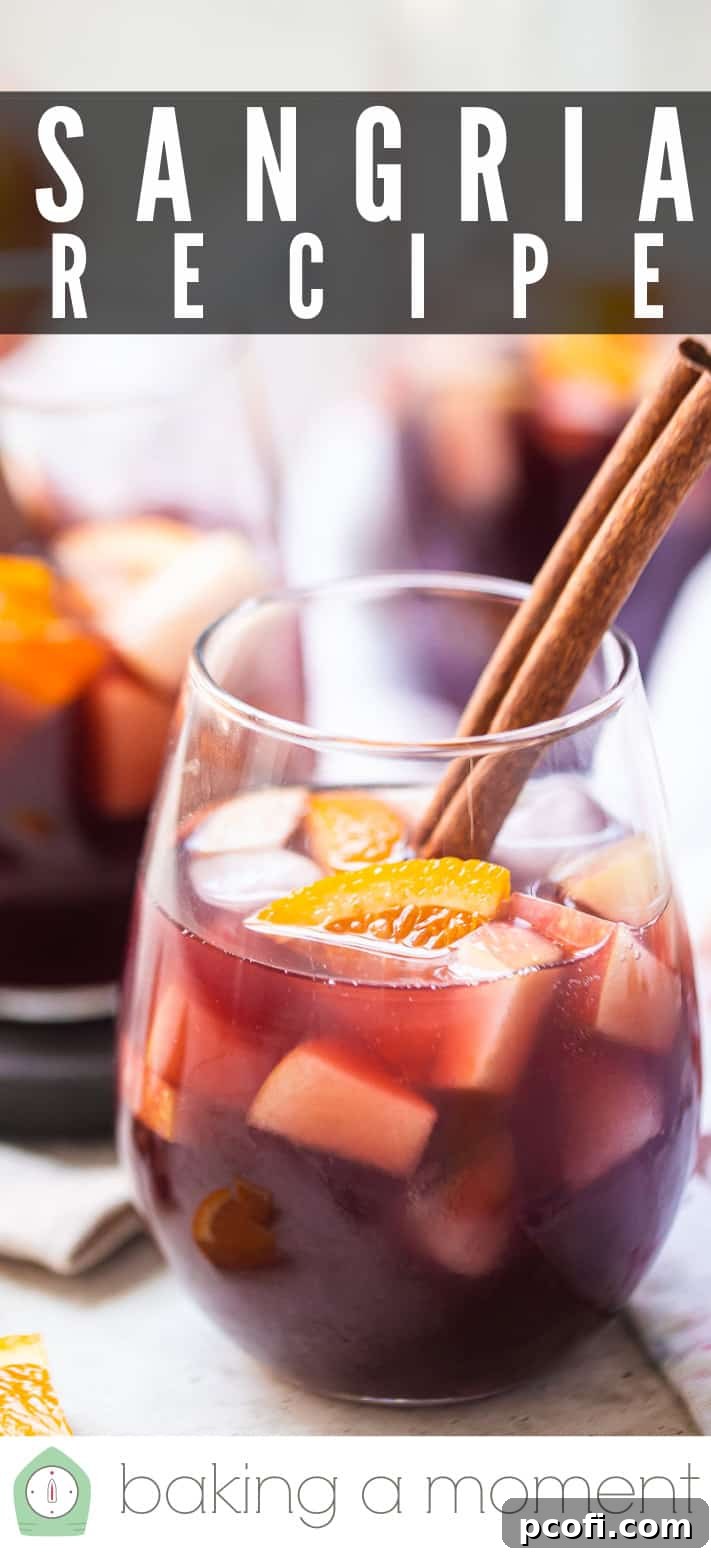 Detail shot of a sangria glass with ice and fruit, emphasizing the inviting textures and colors of this homemade Spanish drink, with 'Sangria Recipe' text.