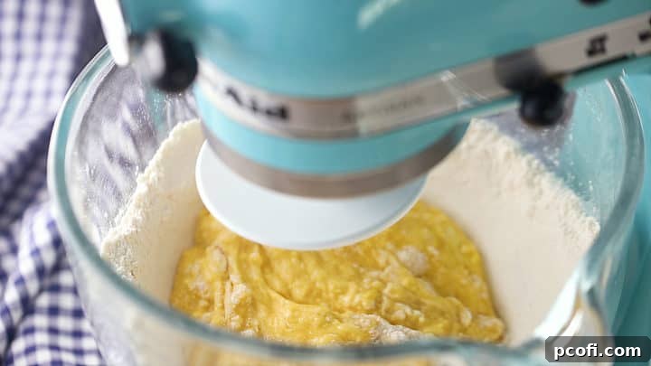 Mixing wet ingredients in to make brioche bread.