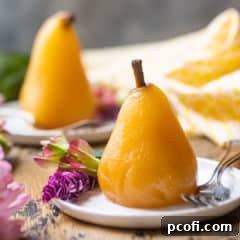 Poached pears served on small ceramic plates with pink flowers.