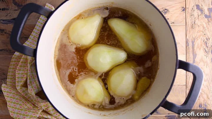 Pears gently poaching in a fragrant liquid, absorbing the rich flavors and aromas.
