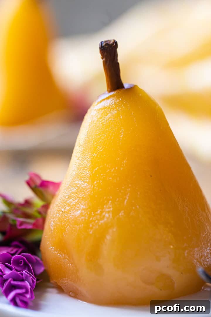 Extreme close-up image of a wine-poached pear, showing its tender texture and rich color.