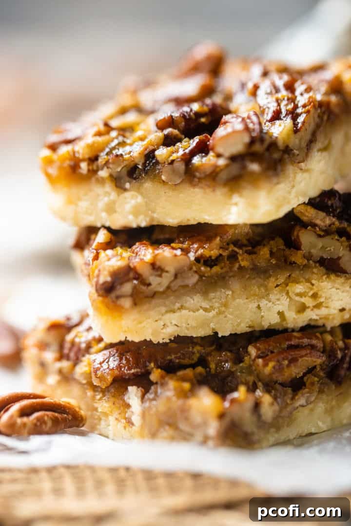 Close-up image of a stack of pecan pie squares.