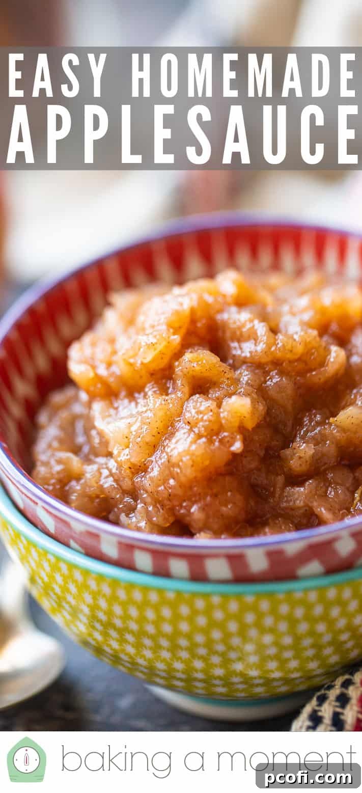 Easy homemade applesauce in a red checked ceramic bowl, garnished with a sprig of mint.