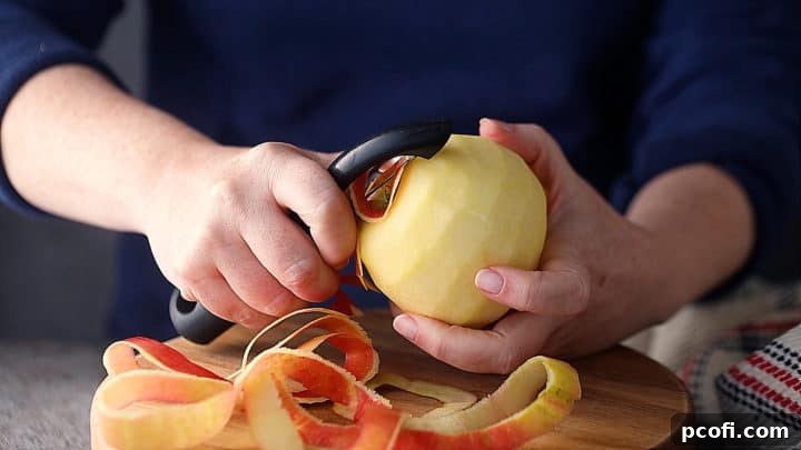 Peeling fresh apples for homemade applesauce.