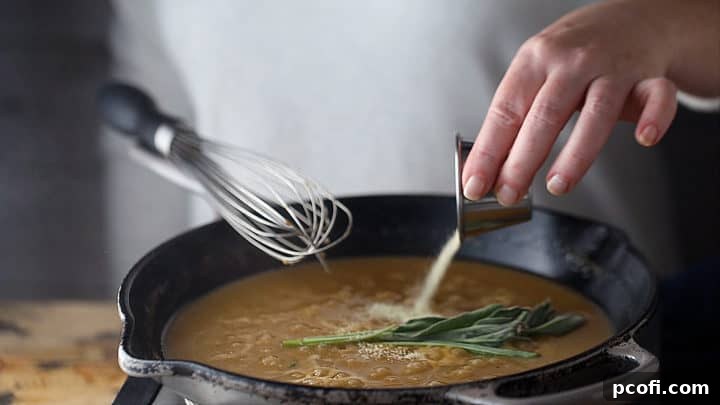 Adding fresh sage, onion powder, and poultry seasoning to gravy.