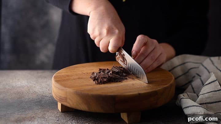 Chopping chocolate bars finely.