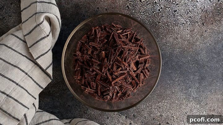 Finely chopped chocolate in a glass bowl.