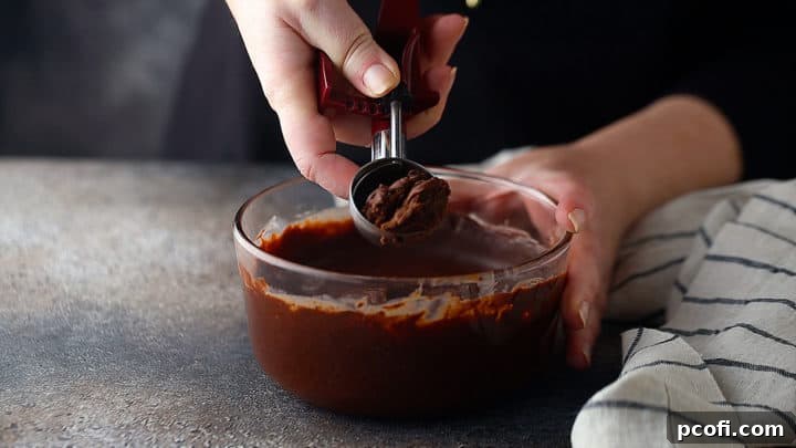 Scooping ganache to make chocolate truffles.