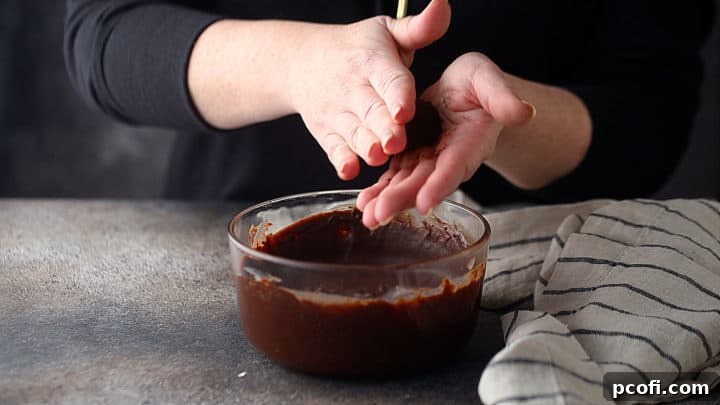 Rolling ganache into balls to make chocolate truffles.