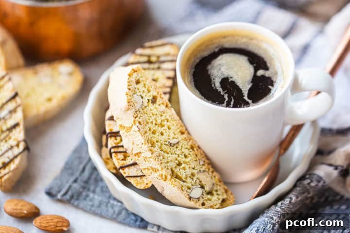 Almond biscotti recipe, prepared and served in a white ceramic dish with a cup of coffee.