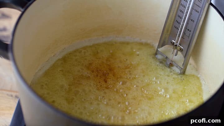 Toffee mixture gently coming to a rolling boil in the pot, beginning its caramelization process.