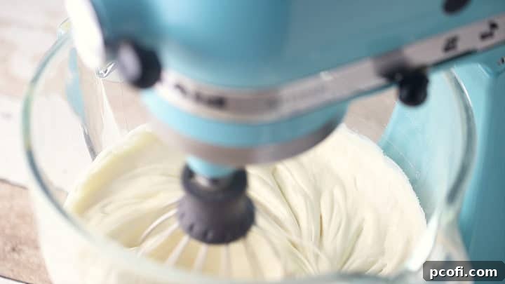 Egg mixture whipped until pale and fluffy, showcasing the significant increase in volume and lightness achieved through proper aeration.