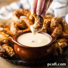 Dipping a homemade soft pretzel into beer cheese.