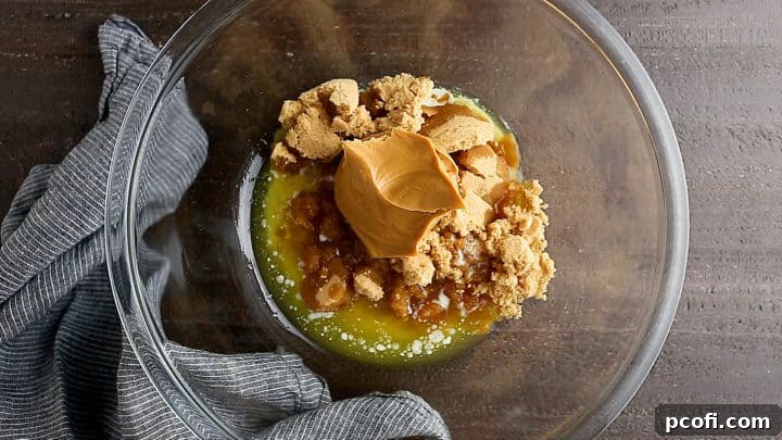 Brown sugar, melted butter, and peanut butter in a large glass bowl.