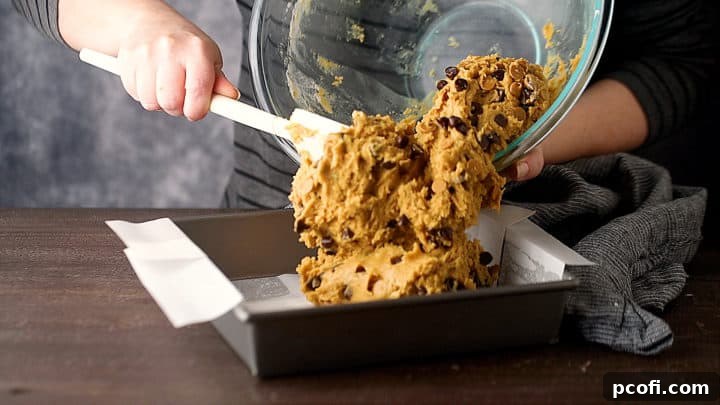 Transferring batter to a prepared baking pan.