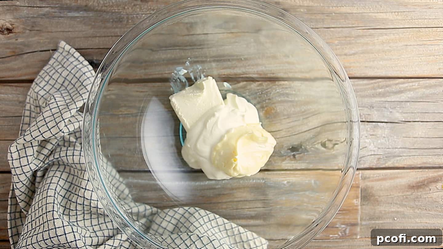 Cream cheese, mayonnaise, and sour cream in a large mixing bowl.