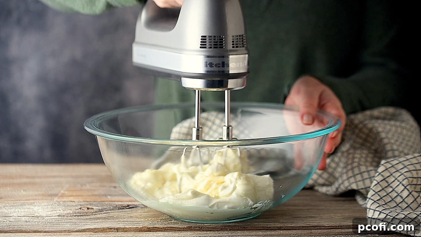 Mixing dip with an electric hand mixer.