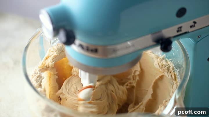 Beating caramel cheesecake ingredients together until smooth.