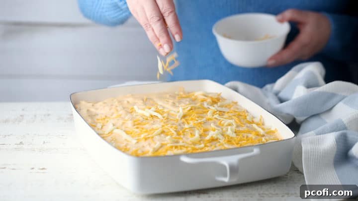 Topping potatoes au gratin with cheese.