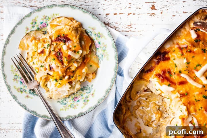 Au gratin potatoes recipe in a baking dish with an individual serving on a vintage plate.
