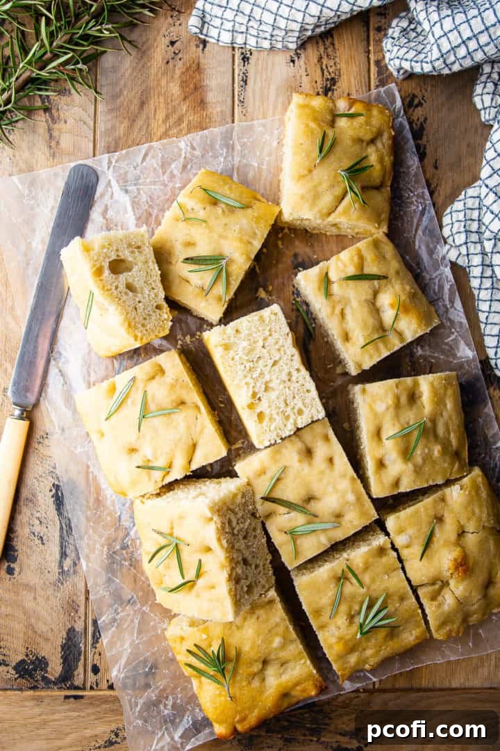 Focaccia recipe baked in a tray and sliced into squares.