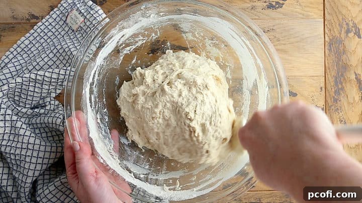 Stirring in flour and salt to create focaccia dough.