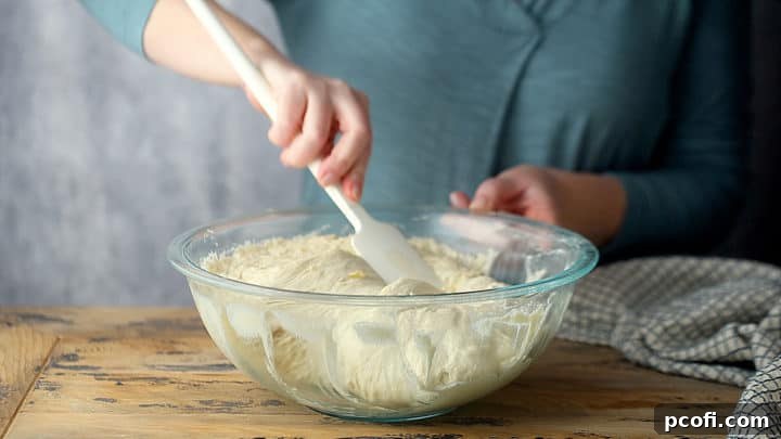 Folding the dough over onto itself.