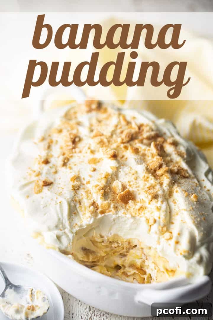 A close-up shot of a pristine white ceramic dish filled with freshly made banana pudding, showcasing the distinct layers. A subtle text overlay reads 'Banana Pudding,' highlighting the star of the dish.
