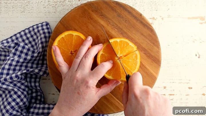 Cutting orange slices into quarters, demonstrating the preparation step for homemade marmalade.