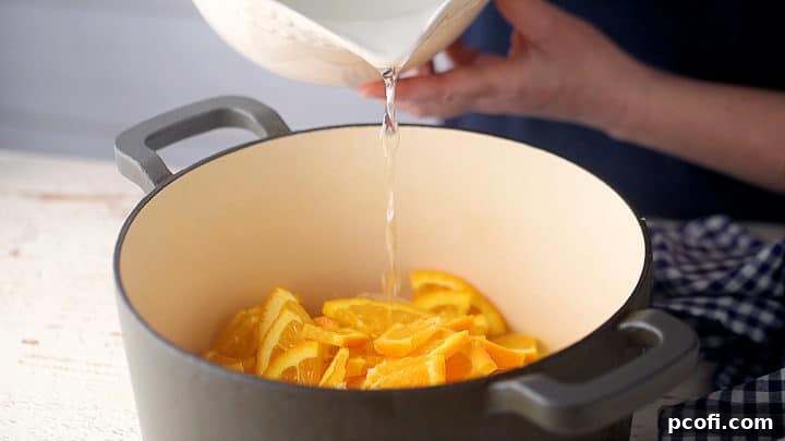 Soaking oranges in water overnight in a large pot to draw out the natural pectin and prepare for marmalade making.