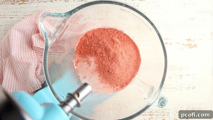 Adding strawberry powder to plain frosting for color and flavor.