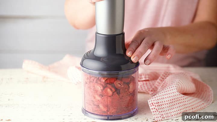 Grinding freeze-dried strawberries to a fine powder, using a mini-chopper.