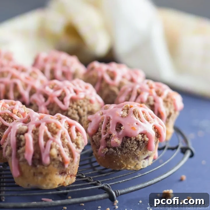 Moist blood orange mini muffins with streusel and glaze, beautifully arranged on a plate