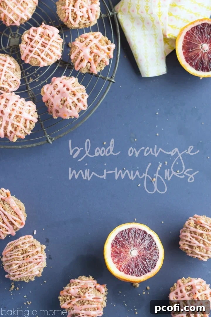A stack of perfectly baked blood orange mini muffins with streusel, ready to be glazed