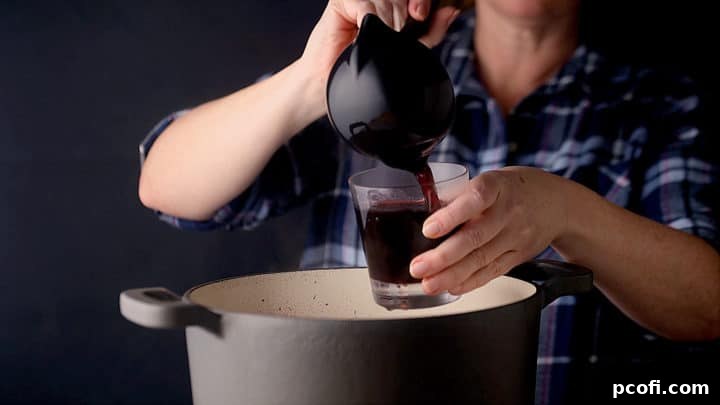 Ladling mulled wine into glasses.