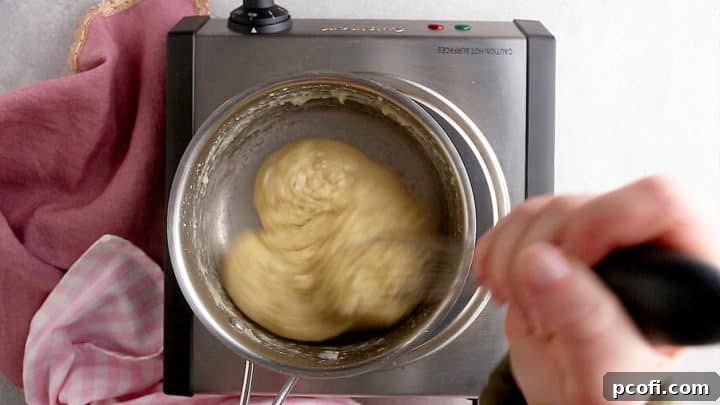 Pâte à choux dough forming a coherent ball, pulling away from the sides of the pot.