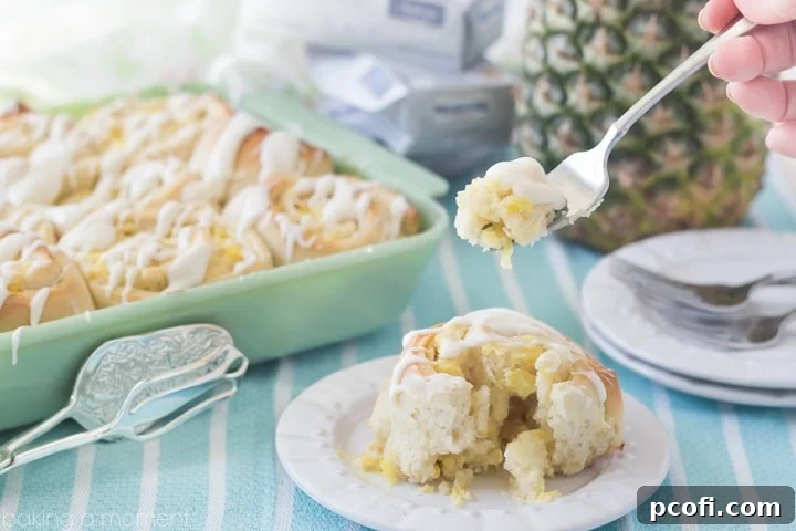 A pan full of warm Pineapple Cream Cheese Sweet Rolls, topped with a generous layer of cream cheese frosting, ready to be enjoyed. A delightful tropical twist on a classic. #OnlyPhiladelphia #MyCreamCheese @LoveMyPhilly #sponsored