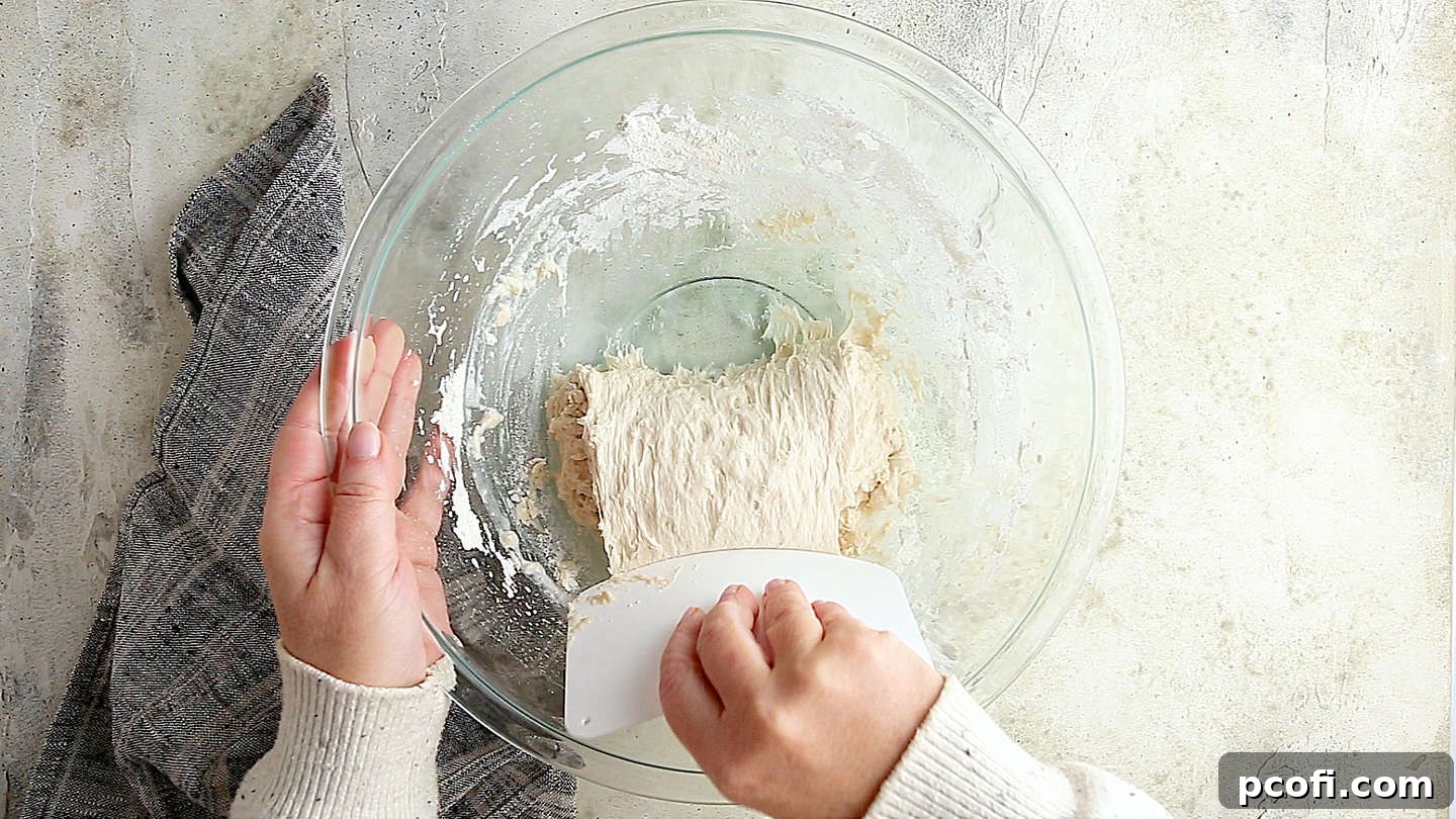 Folding ciabatta dough over onto itself.