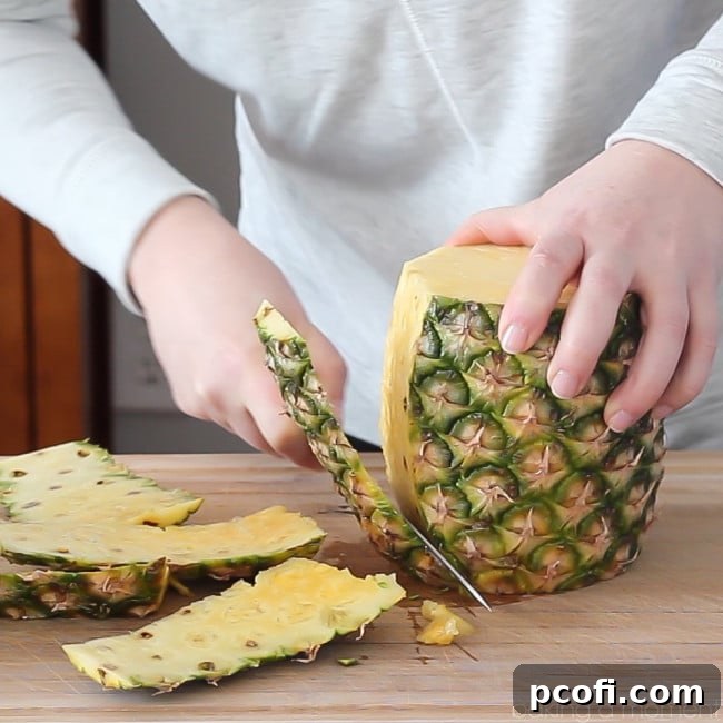 Learn how to cut a whole fresh pineapple into bite-sized pieces quickly and easily with our video tutorial and detailed steps. Save money and enjoy fresher fruit!