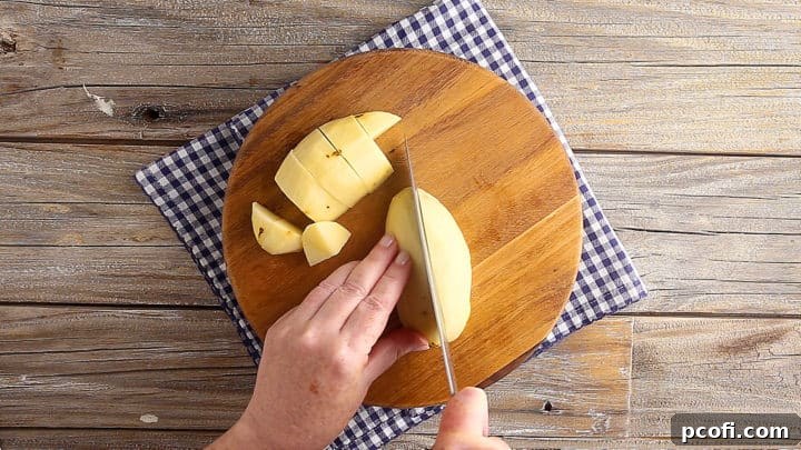 Cubing potatoes into bite-sized pieces for classic potato salad.