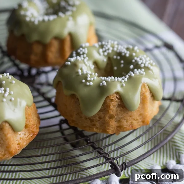 Delicate almond mini bundt cakes with a vibrant matcha green tea glaze, baked with healthier ingredients like einkorn flour and coconut oil.