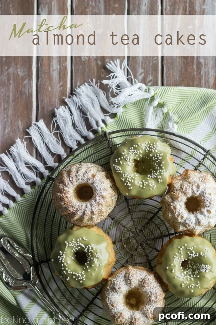A close-up of mini almond bundt cakes cooling on a wire rack, showing their intricate shape, ready for the matcha glaze.