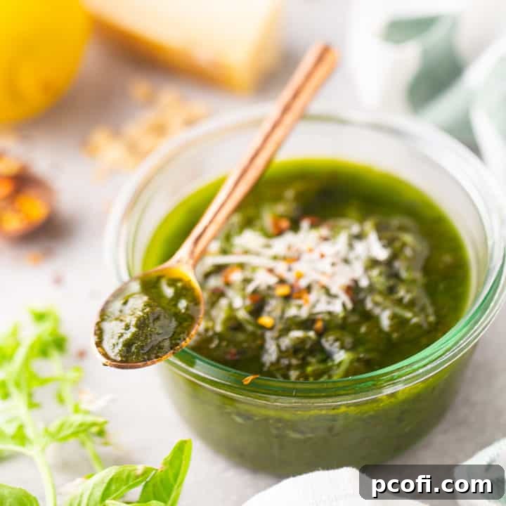 Pesto recipe, prepared and served in a shallow glass jar.