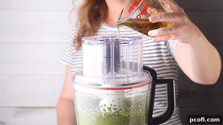 Streaming olive oil into the food processor.