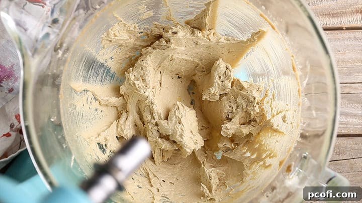Brown sugar cookie dough wet ingredients in a stand mixer.