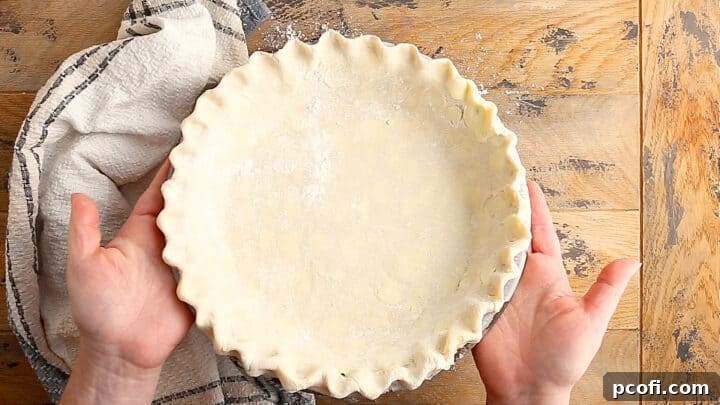 Prepared pie shell chilling in the refrigerator, ready for the delicious apple filling.