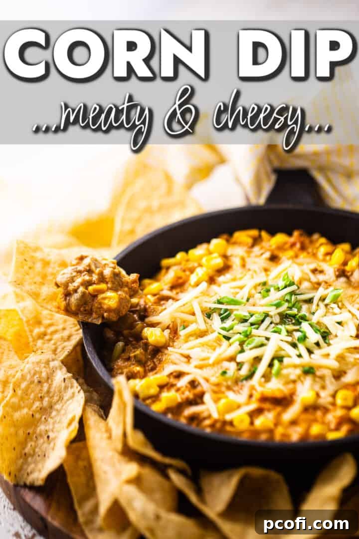 A bubbling, hot Mexican corn dip, generously topped with fresh cilantro, served in a cast iron skillet alongside a bowl of crispy tortilla chips, ready for dipping.